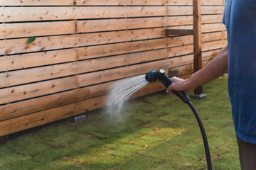 person watering a garden