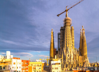 Wide Angle view of the Sagrada Familia during Sunset with Clouds in the Sky