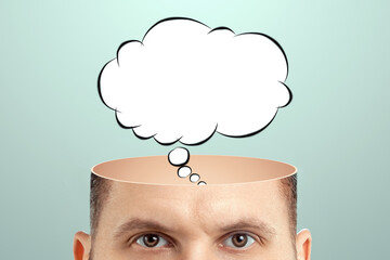 The man thought about it, a sketch of the Cloud Bubble hangs over his head. The concept of dreams, thoughts, idea. Close-up portrait. Creative background, copy space.