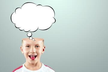 The boy thought about it, a sketch of the Cloud Bubble hangs over his head. The concept of dreams, thoughts, idea. Close-up portrait. Creative background, copy space.