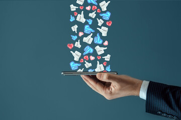 Successful social media advertising strategy. A lot of likes fall on the smartphone. The concept of creative marketing, popularity, many subscribers.