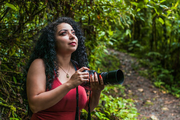 Young Latina girl vacationing and exploring alone a beautiful primary tropical rain forest in a national park of Costa Rica