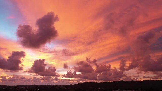 Scene of Colorful romantic red sky sunset with Changing the color of the sky background. .beautiful large red cloud at sunset above Phuket city..beautiful red sky at sunset nature and travel concept