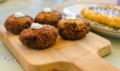 View at traditional Greek zucchini meatballs on the wooden plate