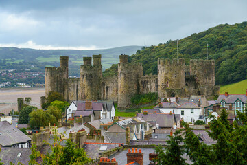 the well preserved and imposing fortress of the 13th century medieval Conwy castle, seen from the Western town wall