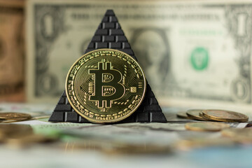 Bitcoin on the background of the pyramid and other money