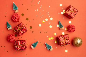 Red Christmas gifts and Christmas trees on a red background. An article about the New year and Christmas. The choice of gifts. A red gift .