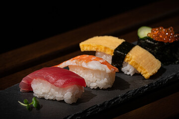 japanese sushi(tsna,egg,shrimp,caviar) and green bud on plate with minimal style