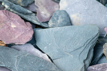 Raw rocks and minerals as natural stones background with crushed and rough material at a rough coast or rocky beach show nuggets and sandstones in harmonic pastel colors as natural mineral background