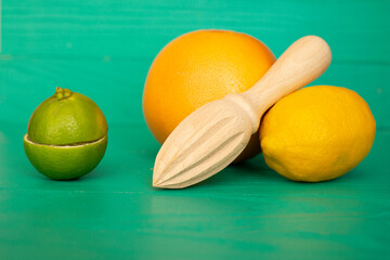 Lime lemon orange with hand press on turquoise background