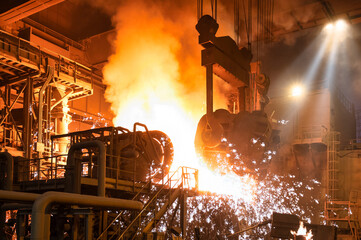 Pouring molten metal into a metallurgical electric arc furnace