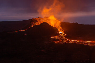 View of volcanic eruption in Iceland. Crater from the volcano Fagradalsfjall at night to the blue...