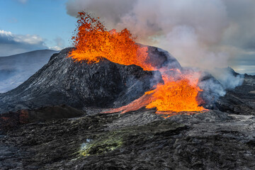 Daytime volcanic eruption on Reykjanes peninsula. Lava shoots up from the crater above. Crater from...