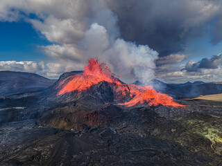 Aerial view of the crater opening from Fagradalsfjall volcano. Crater with strong lava flow on...