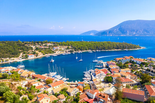 Aerial drone view of Fiscardo village port with luxury boats and yachts on Kefalonia island, Greece.
