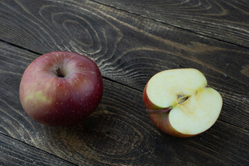 ripe red Apple on a wooden background