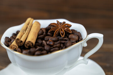 cup of coffee and anise on a wooden background