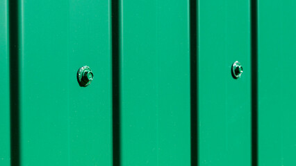 Obraz premium Outdoor garden fence building, new installed base frame with supports for a new metal fence in perspective against the background trees and green grass on summer day