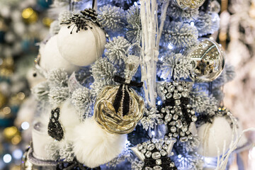 Close up of holidays location with toys and garlands on blue white Christmas tree