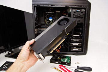 Installing video card in an open case of personal computer. Graphics adapter or graphics card in...