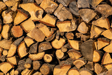 Nicely cut firewood stacked and accumulated wooden texture