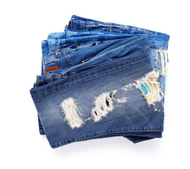 Stack of blue jeans denim with pocket isolated at white background. Jeans heap