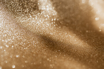 Golden glitter background with small particles