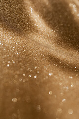 Golden glitter background with small particles