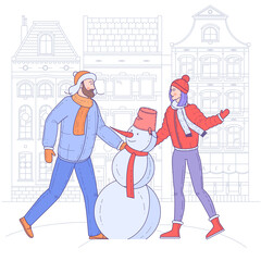 Young couple are making snowman