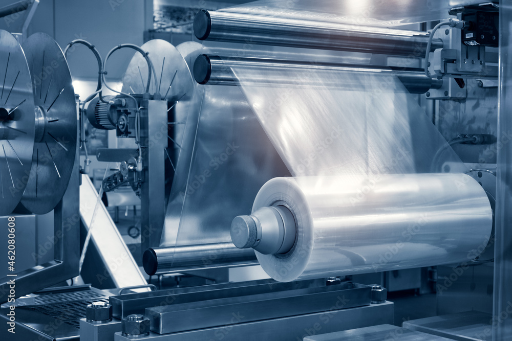 Aufkleber the operation of automatic plastic bag production machine with lighting effect. close-up of the roll