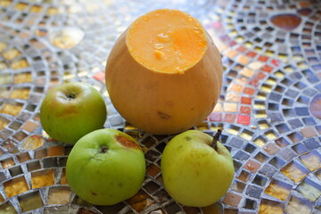 Pumpkin with apples on the table