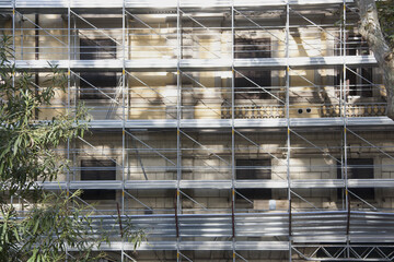 Scaffolding on building facade. Renovation work on a  classic palace.