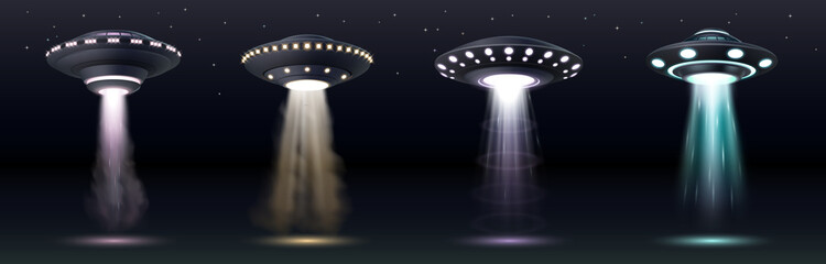 UFO spaceships. Realistic alien space ships with light beam, smoke and sparkles over dark sky © Iryna Petrenko