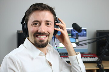 Happy elegant music producer in the studio