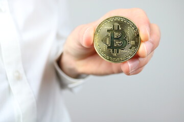 Close up of elegant caucasian man hand holding bitcoin 
