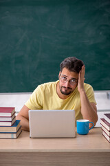 Young male student preparing for exams in the classroom