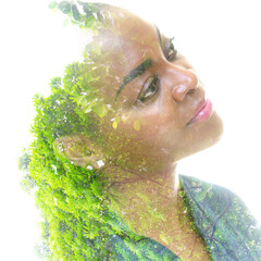 A portrait of a woman combined with green tree in a double exposure technique.Unity with nature.