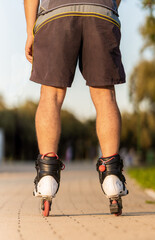 Vertical photo of the legs of a man skating with inline skates