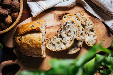 Loaf of sourdough bread on a rustic wooden background in autumn mood