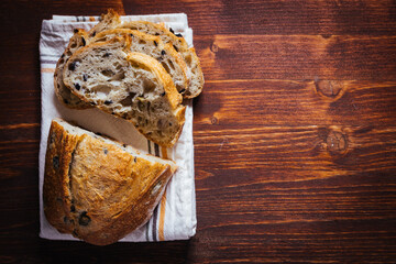 Loaf of sourdough bread on a rustic wooden background in autumn mood