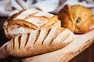 Loaf of sourdough bread on a rustic wooden background in autumn mood