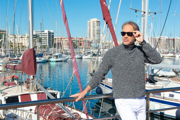 Attractive mature man in a marina in the city