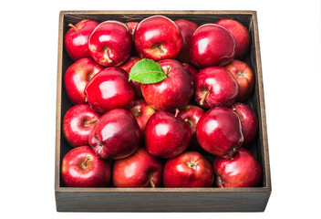 ripe red apples in a wooden box