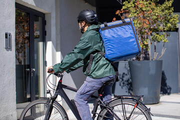 deliveryman on electric bicycle arriving to destination