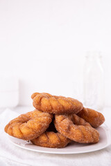 Cinnamon sugar Churro donuts stacked on a plate