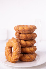 Cinnamon sugar Churro donuts stacked on a plate