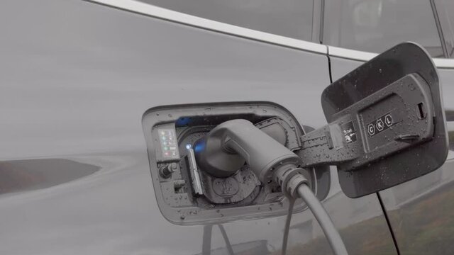 Close up view of electric vehicle with charging cable. Sweden.