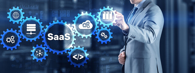 SaaS Software as a Service concept with hand pressing text