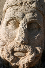 Zeus Statue detail and Mount Nemrut colossal statues guarding ancient tomb, Adiyaman, Turkey. Mount Nemrut in southeastern Turkey and royal tombs is from the 1st century BC.