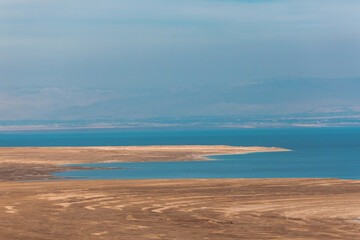 Fototapeta premium Panoramic view of the Dead Sea in Israel and Jordan on the other side. Blue water and Desert. Wild shore of the Dead Sea
